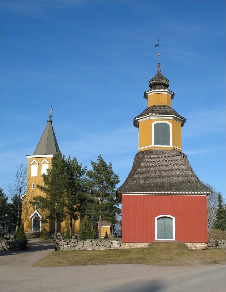Old Kiikala wood church (yellow, behind), in current Salo town in south-western Finland, from year 1859. The wooden tower for the church bell in the front is older, i.e. from year 1800.