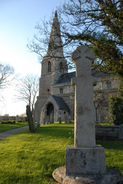 Lampass Cross in St John the Baptist and St Michael and All Angels parish churchyard, Stanground, Peterborough, England. A wheel-headed Saxon stone cross brought from elsewhere in the parish