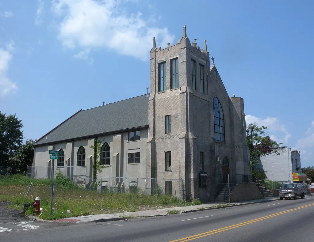 Looking west along Communipaw Avenue (County Route 612) at Clair Memorial United Methodist Church and distant JFK Blvd on a sunny midday. Building is little used since they started meeting at Temple Bethel, north of here on the Boulevard.