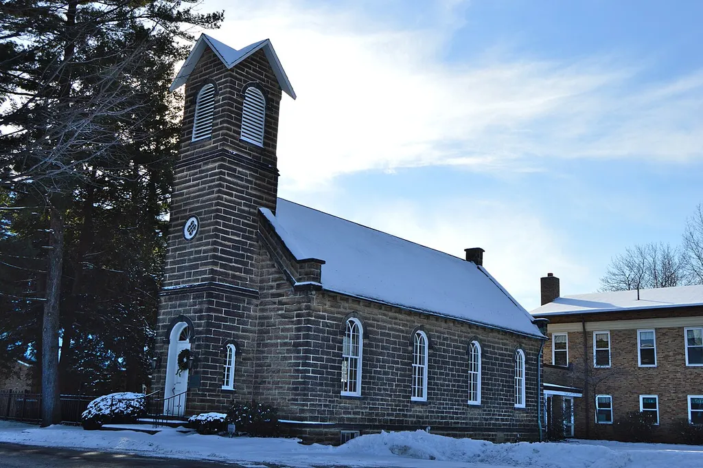 Northern side and front of the Independence Presbyterian Church, located along State Route 21 in central Independence, Ohio, United States. Built in 1853, it is listed on the National Register of Historic Places.