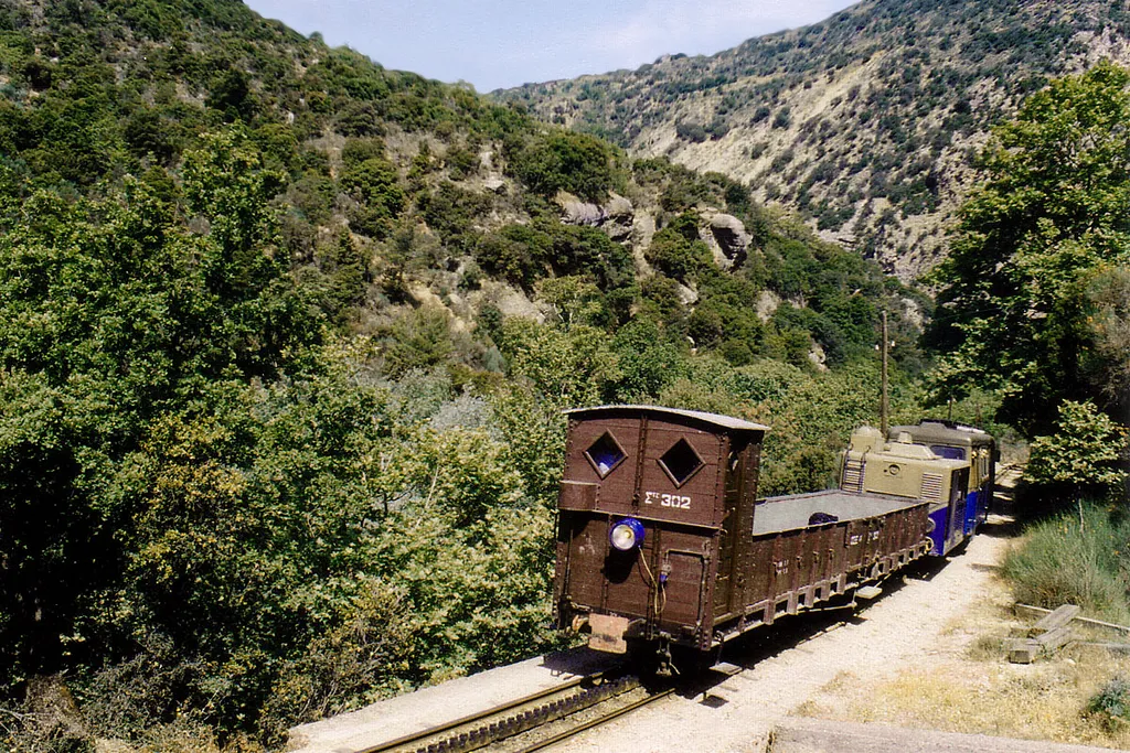 Gorge with mountain creek Vouraikos; 75cm rack train Diakoftó-Kalávryta, Peloponnese. Typical evergreen Maquis shrubland vegetation. Creek water allows deciduous trees.