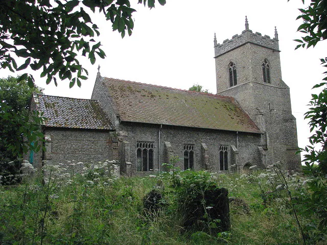 St Swithin's church. The north side, viewed across overgrown churchyard. The chancel is dated by the C12 pillar piscina; the nave and the long south transept - making the church L-shaped > 893531 - 893547 - date from the 13th century; the tower was added a century later. The church > 893331 - 893542 - 893553 was rebuilt and restored in the 18th and 19 centuries but has retained its C14 font > 893554. The stained glass windows are C19 - the east window > 893544 was made by Alexander Gibbs and the south transept windows > 893549 - 893550 are by William Wailes. The grass in the eastern and northern sections of the churchyard has not been cut and conceals an a 13th century stone coffin lid. The church is kept locked but a key is available on request. For more information see: http://www.norfolkchurches.co.uk/bintree/bintree.htm
