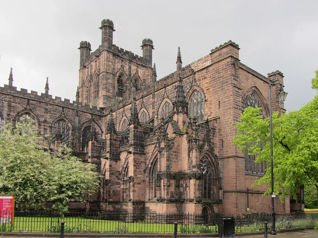 Chester Cathedral, England. The cathedral seen from the south-west looking towards the nave, left, and the unusually large south transept, right. The rebuilding of the nave and the building of the south transept commenced in the early 1300s, but ceased, incomplete, in 1375, and did not recommence until about 1485. The different building dates are revealed in the Flowing Decorated Gothic and Perpendicular Gothic window tracery.