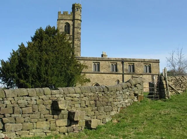 St John The Baptist's parish church, Dethick, Derbyshire, seen from the south. The three steps in the foreground are a stile over the dry stone wall of the churchyard.