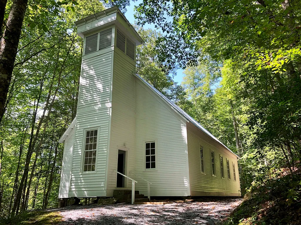 This is the former Oconaluftee Baptist Church located at the former town of Smokemont in the Great Smoky Mountains National Park, near Cherokee, North Carolina. Constructed in 1912, the building was built to house the congregation variously known as the Oconaluftee Baptist Church, Lufty Baptist Church, and the Smokemont Baptist Church, as seen on the variety of names used on the signage near the building and in the existing article about the building. The building remained in regular use until it was bought by the United States Government to become part of the Great Smoky Mountains National Park in 1935. It was listed on the National Register of Historic Places in 1976.