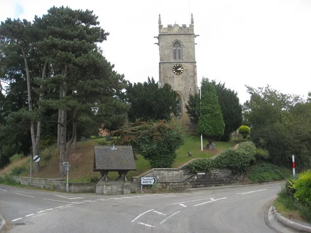 A6075 at Rice Hill, Kirton, Nottinghamshire, with the west tower of Holy Trinity parish church