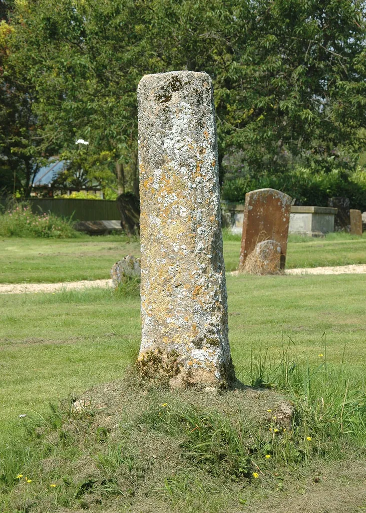 Base and broken shaft of late Mediæval stone cross in St Swithun's parish churchyard, Merton, Oxfordshire