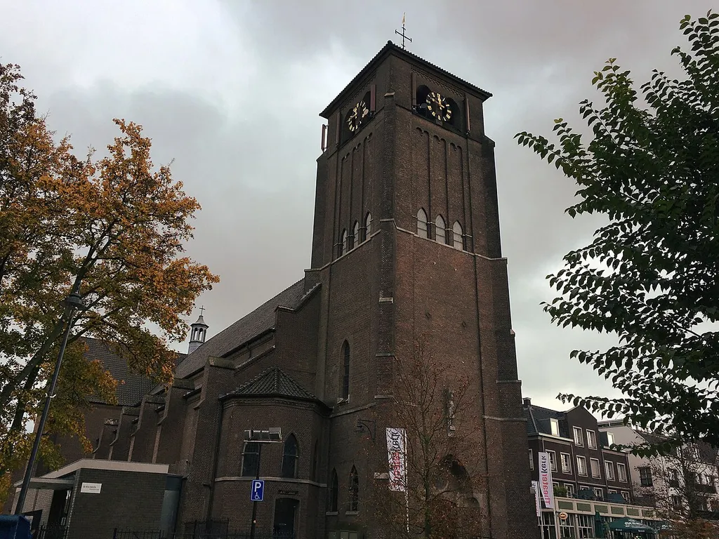 A side view of the Bemmel Theaterchurch on a dark and rainy day in November.