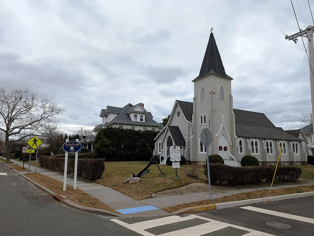Photo of Church of St. Andrew By The Sea in Allenhurst, New Jersey. Photo taken from New Jersey Route 71 (Norwood Avenue) at Elberon Avenue looking northeast. A welcome sign for Allenhurst is also seen here as the road just entered Allenhurst from Loch Arbour.