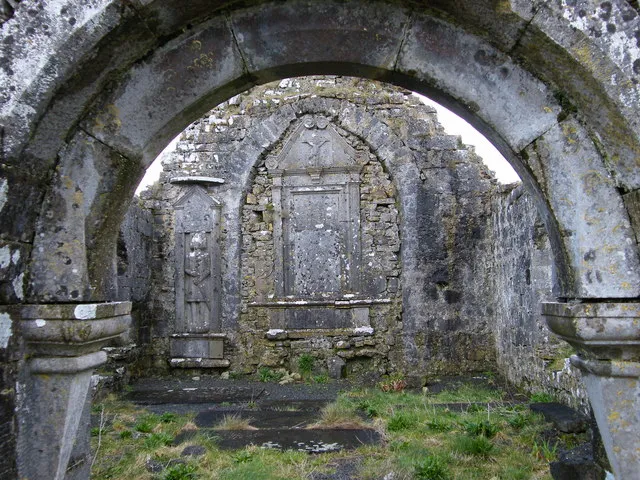 Ballinakill Church, near to Glinsk, Ireland. Inside of ruins of Ballinakill Church at site of former abbey. Tomb fills in former east window. Fine carving of knight to north of window.