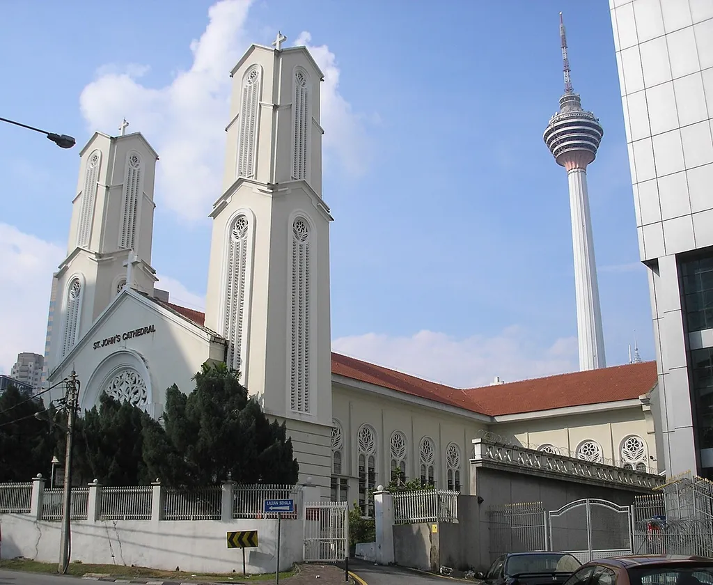Cathedral of St. John The Evangelist at Jalan Bukit Nanas (Bukit Nanas Road), in the Golden Triangle, Kuala Lumpur, Malaysia. The Kuala Lumpur Tower is visible in the background.