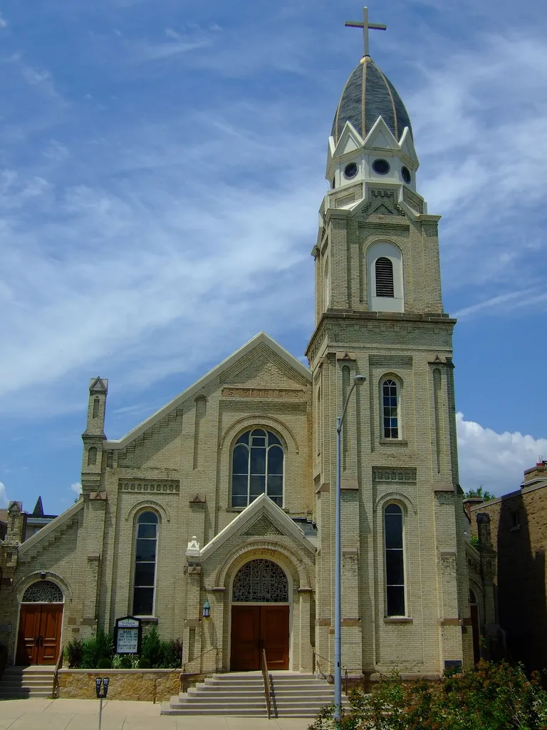 St. Patrick's Roman Catholic Church (1888-89) in Madison, Wisconsin. Designed in a late 19th-century eclectic style by Madison civil engineer and architect John Nader, this church is the third-oldest Catholic parish in the city. It was dedicated on St. Patrick's Day in 1889, with Archbishop Heiss of Milwaukee in attendance. Since its construction by local builder Timothy McCarthy, the church has undergone several major alterations, including a widening of the entire structure in 1903. It was added to the National Register of Historic Places in 1982.