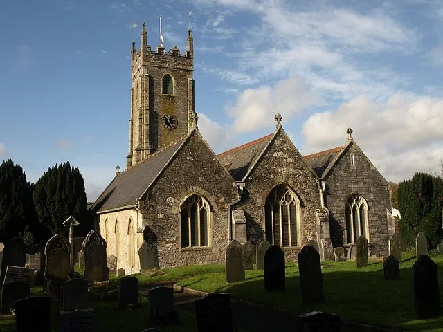 St Mary's church, Tamerton Foliot. Very similar to 84135, and the most striking view of the church, with its three gables, "the roofs made uniform in the C19" (Cherry &amp; Pevsner), and the tower rising above. This is taken from near the gate at the east end of the churchyard.