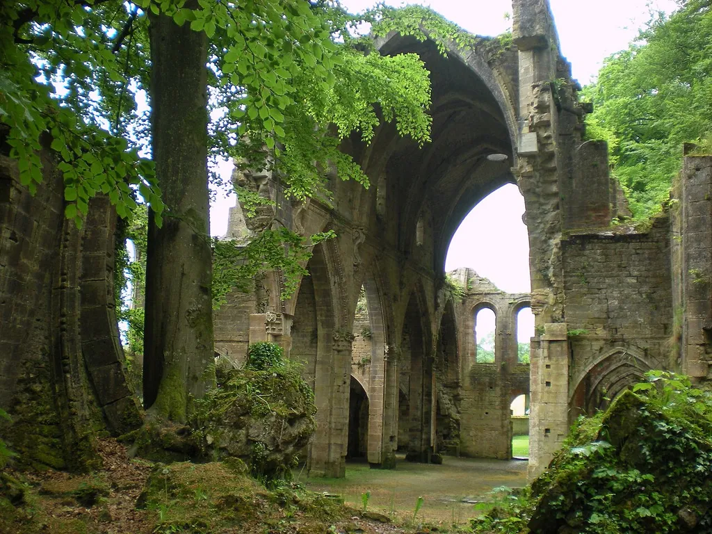 View of Trois-Fontaines abbey church from east-northeast, showing partially intact fallen transverse arch in left foreground; Trois-Fontaines-l'Abbaye, Marne, France.