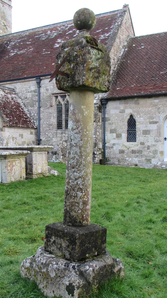 A curious 3-faced sundial in the churchyard of All Saints church in Sutton Mandeville, near Salisbury, Wiltshire. About 2 metres tall the date 1685 is engraved just below the ball finial.