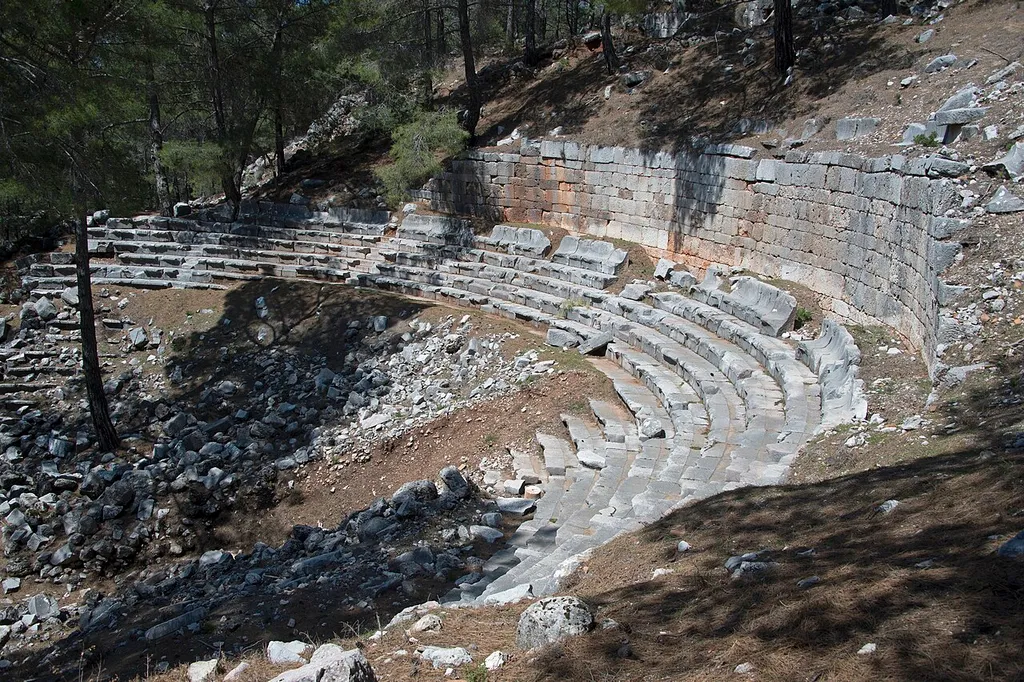 Cadianda’s name was read as “Kadawanti” in the Lycian inscriptions. Because of the suffix “-nd”, it can be said that the history of [the] settlement dates back to 3 thousand BC. However, the oldest remains of the ancient city that have survived on the surface do not go [back] more than [to] the 5th century BC. Part of the ruins of city walls surrounding Cadianda, tombs and some of the inscriptions are the only remains dated to the earliest period. The city is surrounded by walls which were rebuilt many times due to the topography and the steep slopes of the land. The theatre is a high-light for a visit. It used to be heavily overgrown, but has been cleared. It could contain some 5000 people. Only the seating area is well-preserved.