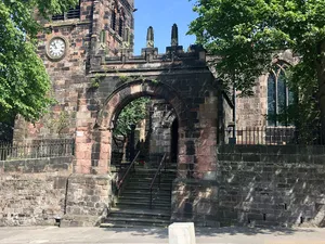 Lych gate, walls, railings, gate and gate piers to churchyard of St Edward
