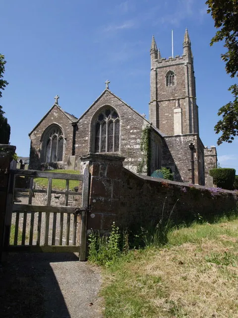 St Mary's church, Lifton The church, with big pinnacles on its west tower, sits just above the village centre, and just north of a gridline. Seen from the grassy bank beside Parsonage Court.