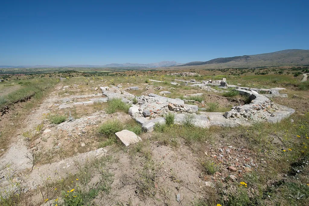 Northern Church. Tha basilical plan is on an east-west direction and measures 42 x 23,5 m. including the narthex. The church is divided into three naves, and the side naves are 4,05 m and the central nave is 10,10 m wide. The main apse is triple façade on the exterior and semicircular on the interior. The structure is damaged to the level of stylobat. The most intact part is the main apse. In the construction of the church, collected blocks are used as well as local grey stones. The brick paved ground in the north nave is partly, and a very small part of the mosaic floor in the south nave is conserved. The superstructure of the church cannot be determined. In addition to the door giving access from the north, there is another door obtaining passage from the south nave to the apse. In the west of the church, the narthex that is disassembled to the level of foundation and annexed spaces take place (in many texts “take place” seems to be Turglish for “are situated”). In the church at least two phases are determined. The annexes built in the north of the church indicate the 2nd phase. However, the column capitals must have been carried to the Northern Church from another building. The church is smaller than Great Basilica in terms of dimensions; howver, it is larger than the Central Church. When the construction date of the other two churches, the date of the column capitals, and the architecture of Early Christianity in Antiocheia are considered, the construction date of the Northern Church is the late 6th century AD at the earliest.