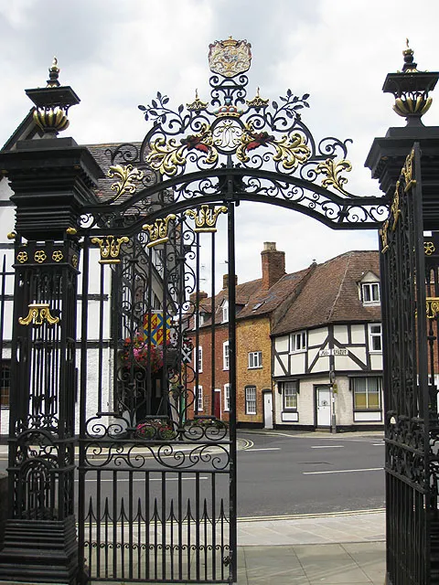 Abbey gates The gates of Tewkesbury Abbey lead out onto Church Street at its junction with Mill Street which can be seen as it heads down to the Mill Avon.