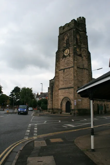 Christchurch Methodists Landmark on the corner of Derby Road and College Street. The clock was stuck at ten past six for a long time, until some wag moved it to ten past five at the start of BST. It's now working. In the foreground is a decorated awning on a corner shop - currently a barber's.