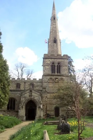 Steeple and north porch of the parish church of St Mary the Virgin, Church Street, Burton Latimer, Northamptonshire, seen from the north