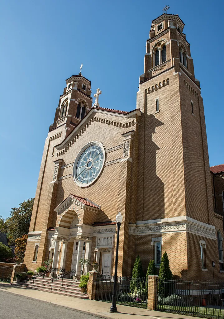View of the front of St. Vitus Church, located at 6019 Lausche Avenue in Cleveland, Ohio, in the United States. St. Vitus Parish was organized in 1893. A $6,000 church was constructed in 1894 at 6111 Glass Avenue (now Lausche Avenue). St. Vitus School was constructed on the site in 1912. With the parish rapidly outgrowing its church, a new, vastly larger church was constructed at 6019 Lausche Avenue and completed in 1933. Designed by local architect William Jansen, this Lombard-Romanesque Revival structure of pale yellow Falston brick cost $350,000 (about $6.5 million in 2016 dollars). The church interior was renovated and conserved in February 1993 during the parish's centennial celebration.