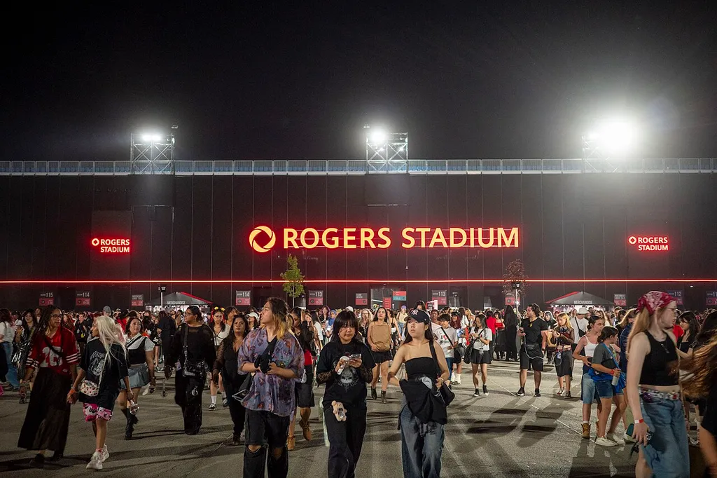 The illuminated Rogers Stadium sign is seen from the fan plaza. The sign is attached to the backside of the north grandstand, facing Gate 1 near Downsview Park station. The photo was taken following the inaugural concert by Stray Kids on Sunday, 29 June, 2025.