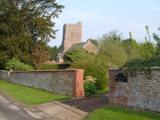 Holcombe Burnell church. St John's church, seen across the garden wall of the manor house, and near the end of one of Devon's more charming cul-de-sacs.