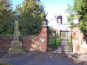 Churchyard walls, gates and war memorial to south of All Saints Church