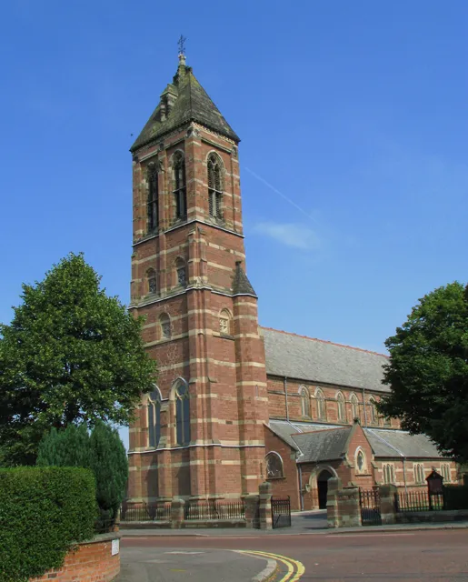 St Mark's Church, Dundela, Belfast. St Mark's Church, Dundela (Church of Ireland), located on the Holywood Road in east Belfast. Designed in red sandstone by the eminent Victorian architect William Butterfield in Gothic revival style. The 150ft high bell tower creates the impression of a larger church.Sir John Betjeman described St Mark's as "Butterfield at his best".