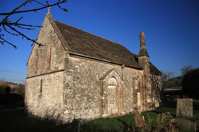 Church of England parish church of St Margaret, Knook, Wiltshire. This is a view of the back of the church where its chimney can be seen. The church dates from the C11, but is mostly of the C14 and C17. It was restored by William Butterfield in 1874-76.