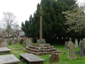 Cross and stepped base east of path to south porch of Church of St John the Baptist