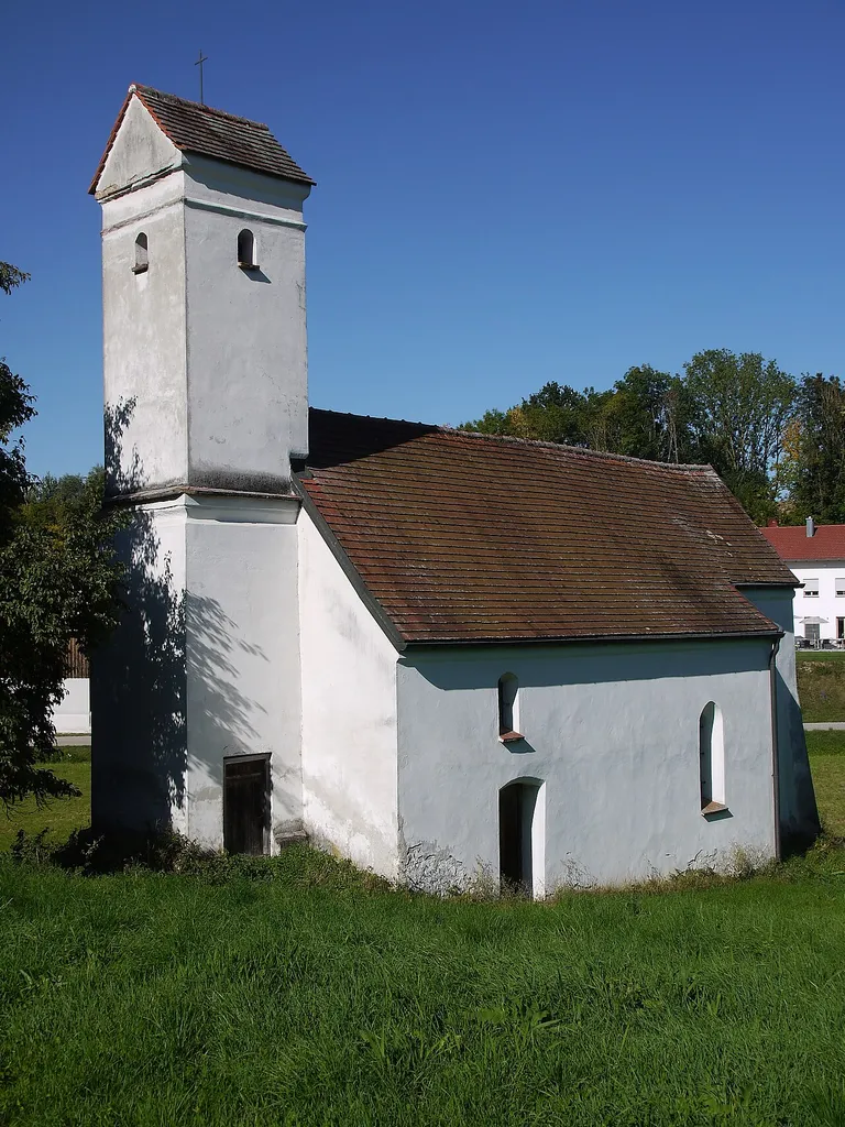 Small hall church with a straight choir apse and west tower, late 13th century.