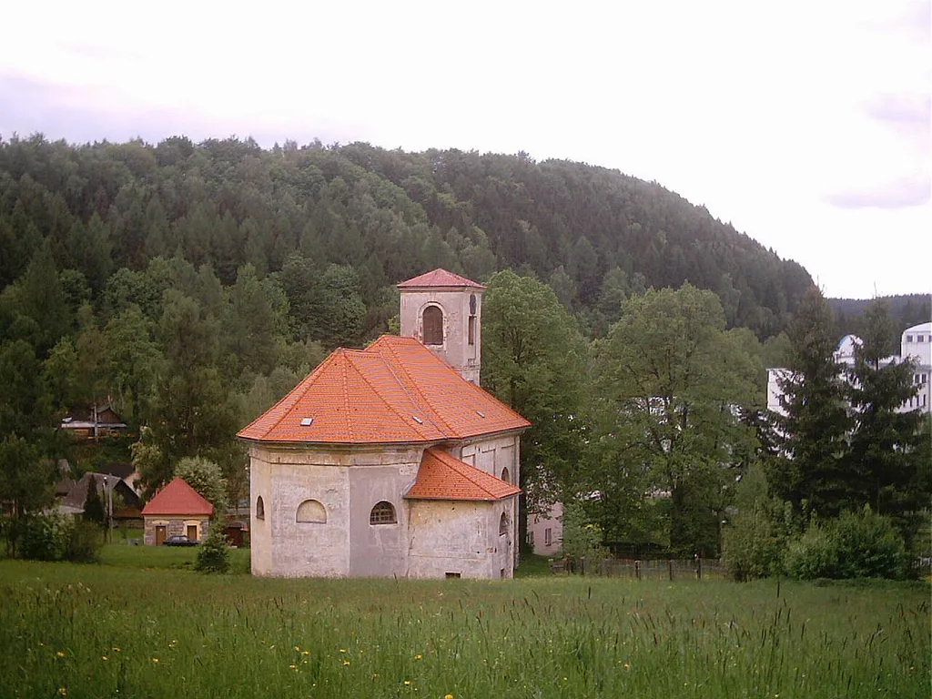 The image shows a village church (w:cs:Kostel Povýšení svatého Kříže (Adršpach)) of village Adršpach (Adrspach) in NE Bohemia (Europe, Czech Republic). Author is Vladimíra Kosičková (Vladimira Kosickova).
