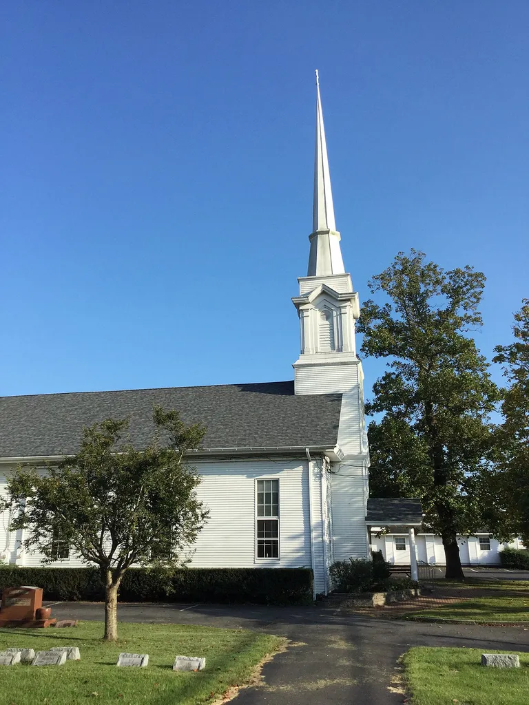 The Absecon Presbyterian Church (208 New Jersey Ave., Absecon, Atlantic County, New Jersey) seen from the northwest side, including the steeple above the church's front door and part of the attached graveyard. The congregation was organized in 1859 and the church was built starting in June 1865 and dedicated 20 June 1867, according to the Atlantic County Historical Society; its historical marker was erected in 1978 by the Atlantic County Cultural and Heritage Commission.