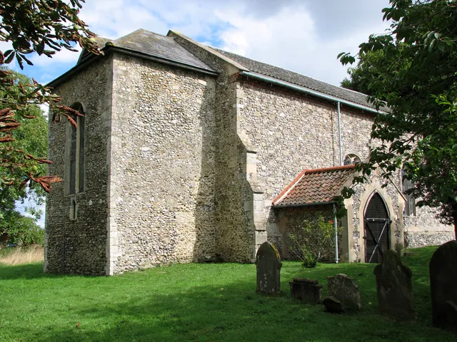 St Andrew's parish church, Hoe, Norfolk, seen from the southwest. It had a 13th-century west tower, of which only the first stage (left) now remains.