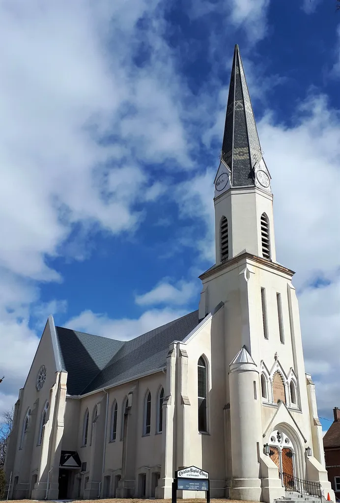 The Christian Baptist church was built in 1874, in the original downtown core of Newmarket. The church began in 1822, and this structure was the third built for the Christian church denomination. The tower, with its large polygonal steeple, is centered in its Latin cross plan and is one of the oldest operating churches in Newmarket.