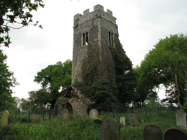 The ruined church of All Saints Only the tower remains. The ruin, surrounded by the churchyard, is fenced off.