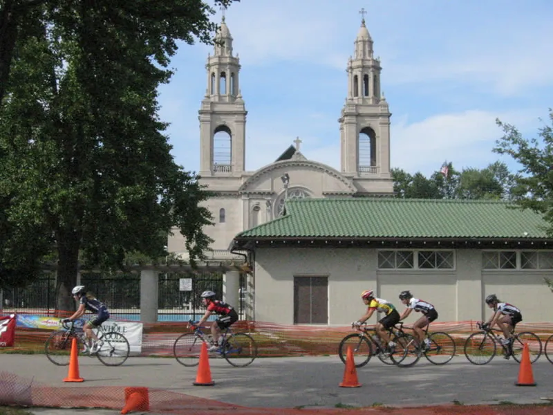 Bicycle racers at a park with a perfect little racecourse, even if most of them found it awfully remote. The little pool service building in the foreground can't ruin the view of the terra cotta (and unfortunately abandoned) church.
