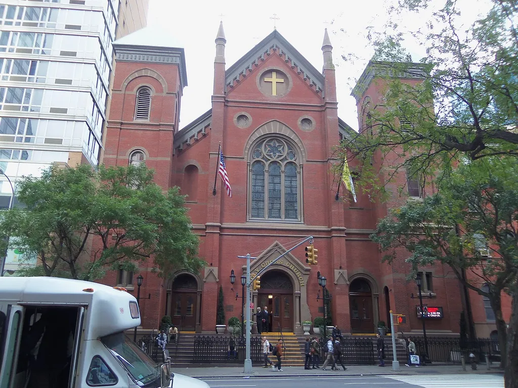 The Roman Catholic Church of the Holy Cross on 42nd Street between 8th and 9th Avenues in the Theatre District of Midtown Manhattan, New York City. Built in 1870, designed by Henry Engelbert. The rectory is on the right. This was the parish church of Father Patrick Duffy, for whom Duffy Square (the northern part of the Times Square intersection) is named