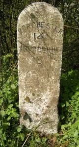 Milestone, entrance to Dunn's Farm 150m S of church.
