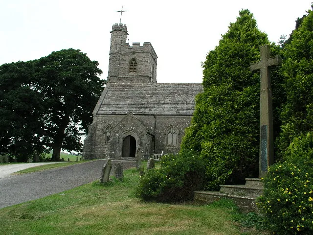 St Patrick's parish church, Preston Patrick, Cumbria, seen form the south. The stone cross on the right is the parish war memorial.