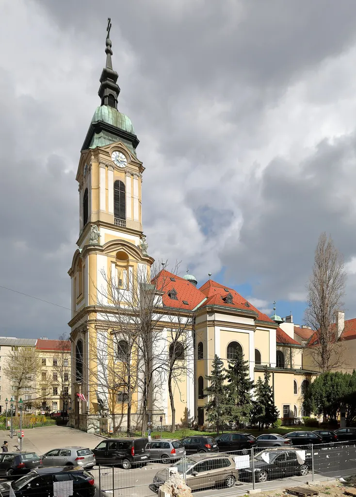Südwestansicht der Leopoldskirche am Alexander-Poch-Platz im 2. Wiener Gemeindebezirk Leopoldstadt.Die Kirche wurde an Stelle einer 1671 errichteten Vorgängerkirche von 1722 bis 1724 nach Plänen von Anton Ospel errichtet und 1779 geweiht. Am 12. März 1945 wurde die Kirche durch Bomben schwerstens beschädigt. Der Wiederaufbau (1946–1948) erfolgte unter der Leitung der Architektin Helene (Hella) Koller-Buchwieser. Endgültig war dieser Wiederaufbau (Wiederinstandsetzung) erst durch die Außenrenovierung (1959–1961) abgeschlossen, die wiederum Frau Koller-Buchwieser leitete.