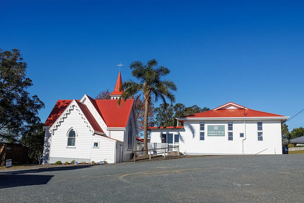 Mahurangi Vineyard Church (formerly St Columba's Presbyterian Church) and Wilson Memorial Hall in Warkworth, New Zealand, viewed from the northwest.
