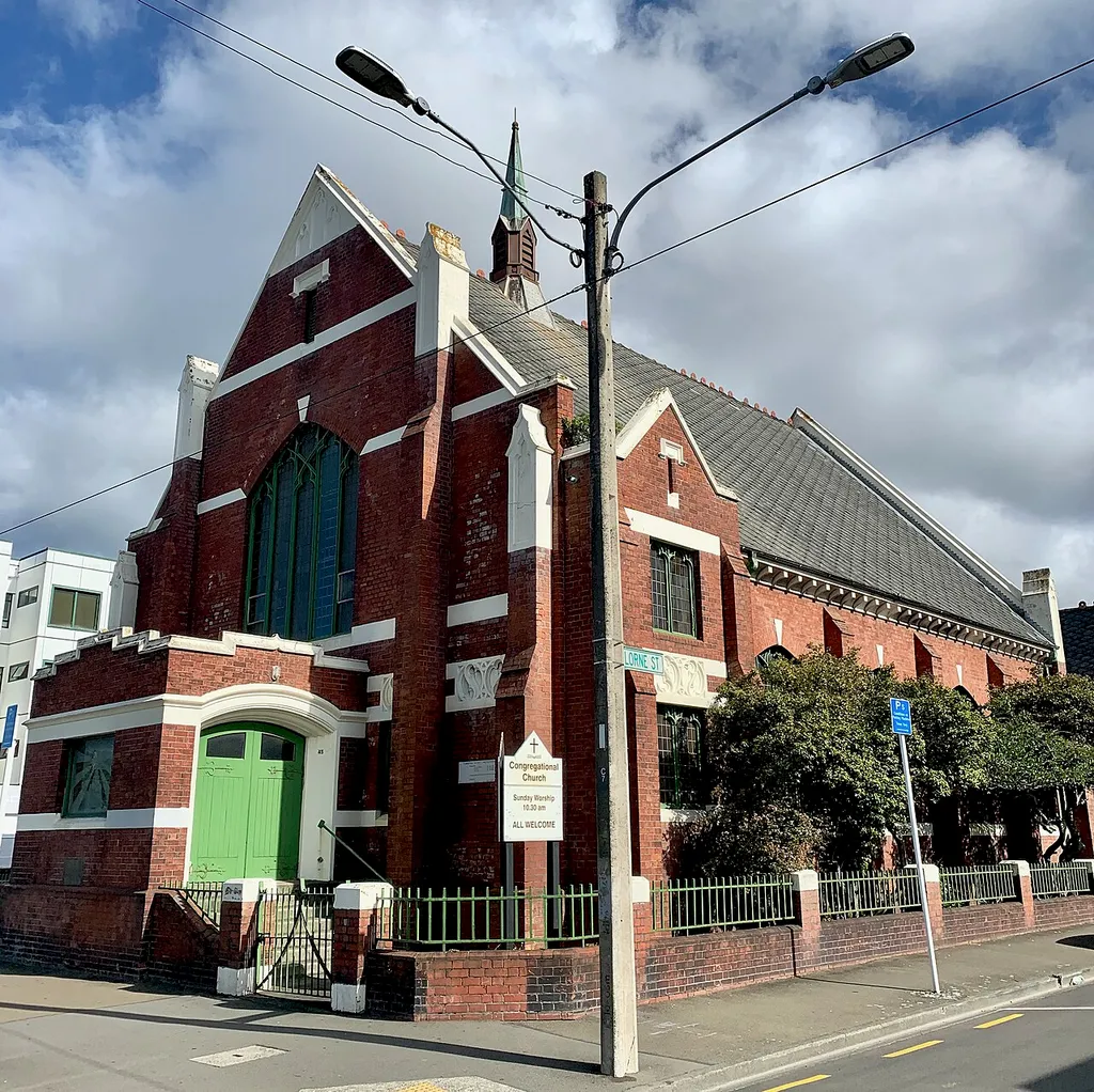 This is a photograph of the Congregational Church at 45 Cambridge Terrace, Wellington, New Zealand. According to http://wellingtoncityheritage.org.nz/buildings/1-150/54-congregational-church, "The Cambridge Terrace Congregational Church is associated with the fortunes of a small, non-conforming congregation that established itself in the city during the 1870s. The church is sited away from the more prestigious locations of mainstream churches in Wellington, and the building does not have high public recognition."