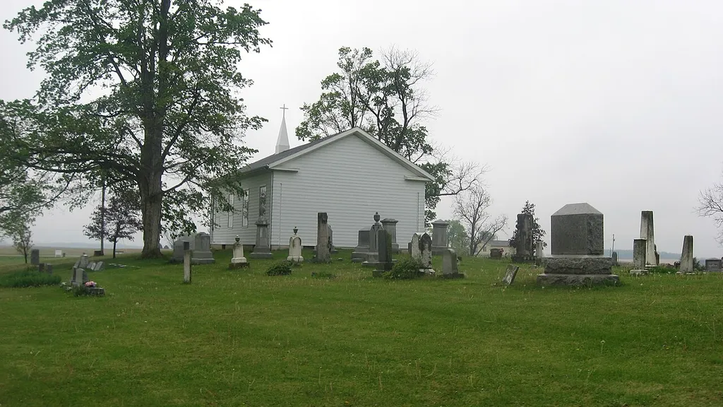 Rear (northern) view of Bethel Church, located at 1782 E. Bethel Road (E1160N) east of Attica in Logan Township, Fountain County, Indiana, United States. Built as a Methodist church in 1850 in the Greek Revival style, the church has been re-sided and lost its original appearance; nevertheless, it and the cemetery are listed together on the National Register of Historic Places.