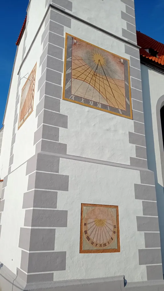 Sundial on the tower of the Church of the Assumption in Kájov, South Bohemian Region, Czechia