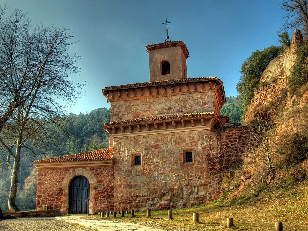 Los orígenes del Monasterio de Suso hay que explicarlos necesariamente a partir de la vida del santo Millán. Es el santo el que da nombre al valle y al pueblo, a las devociones y al monasterio. Millán vivió como un anacoreta en unas cuevas, donde hoy está el monasterio, en las que fue también enterrado en el año 574. The Monastery of Suso was the scene for the appearance of the first words of Castilian or Spanish and also of the first poems in our tongue. It was declared a World Heritage site on 4 December 1997