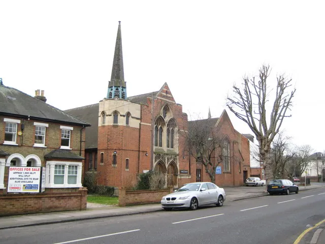 Christ Church, Hanworth Road, Feltham, Middlesex, seen from the east. It was completed in 1909 as the Feltham Wesleyan Church and later became Hanworth Road Methodist Church. In 1976 the Victoria Road United Reformed congregation sold its church and merged with Hanworth Road Methodist Church, which became the United Free Church (Methodist/United Reformed). In 1981 the Church of England parish of St Catherine merged with the United Free Church, which became Christ Church. The tip of the spire of the former St Catherine's parish church is visible above the church hall roof.